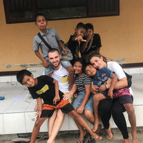 Group picture of 2 volunteers and their students