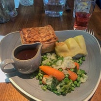 dinner of pie and mash with some vegetables