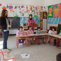 Student helping to teach English to preschoolers