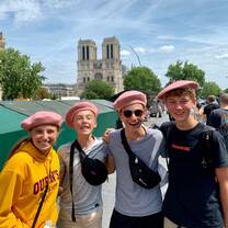 Students in berets in front of Notre Dame