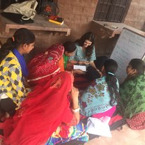 This picture shows me with my English advanced class, the Sunflower group. We often read English moral stories together.