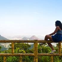 Girl sits on fence in Rio de Janeiro