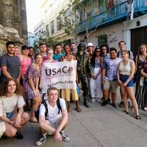 A group of students pose in La Habana with a USAC sign.