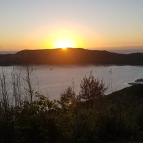 The sun rising over a small bay taken from a hill above Somosomo.