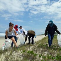 Volunteers help clean up plastic pollution on the beach