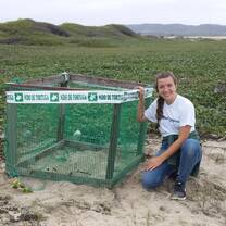 A volunteer helps protect vulnerable sea turtle nests in Ecuador.