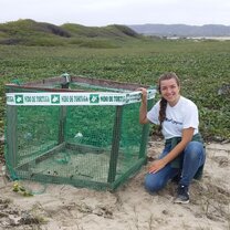 A volunteer helps protect vulnerable sea turtle nests in Ecuador.