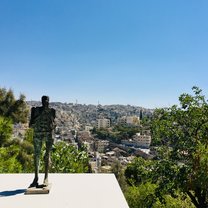 Looking over Amman with a small metal statue in the foreground.