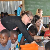 Helping village children with their homework Helping village children with their homework