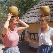 African women carry pots on their heads with ease, lets try