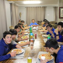 Sharing tales of the day around the dinner table Volunteers from Ivy League at the dining table.
