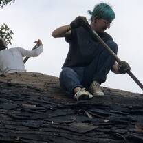 2019 Semester Program students work on removing shingle roofing.