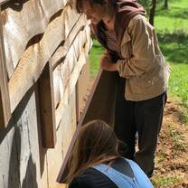 2019 Semester Program students install insulation on a new solar bathhouse.