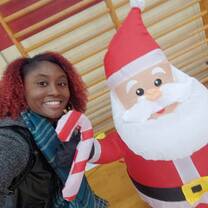 Shaniya, an RVF International participant, celebrating Christmas at her Spanish school with a festive inflatable Santa, showcasing the joy of cultural exchange and holiday traditions while teaching in Spain.