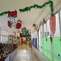 A hallway in Shaniya’s school in Alicante, Spain, beautifully decorated with Christmas stockings, garlands, and student crafts, showcasing the holiday celebrations and cultural exchange experienced through RVF International's Teach English in Spain program.