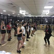 a bunch of participants in a dance hall taking dance lessons
