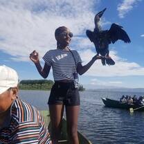 A student holding a cormorant
