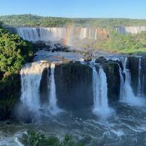 waterfall scenery with rainbow in the sky