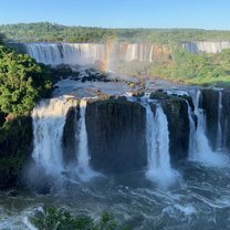 waterfall scenery with rainbow in the sky