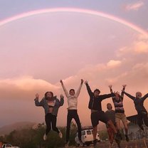 My advisee group jumping for joy beneath a rainbow