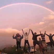 My advisee group jumping for joy beneath a rainbow