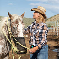 Participate in ranch chores, like graining your horse before saddling up for a ride.