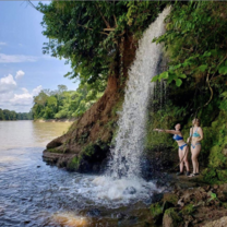 waterfall Two Hoja Nueva interns standing enjoying the Piedras Waterfalls