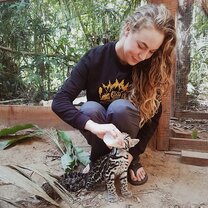 Hoja Nueva's Founder Sam feeding a young ocelot.