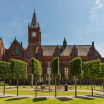 University of Liverpool campus surrounded by green trees & grass and our historic red brick buildings