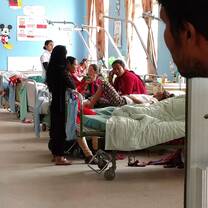 A photo of travelors interacting with patients in a clinic.