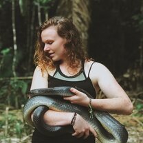 Nadine holds a friendly Clelia clelia in the Amazon.