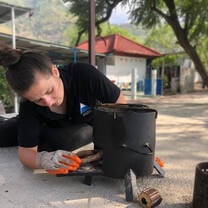 Trekker working on engineering stove