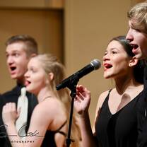 Four singers in a cabaret style environment.
