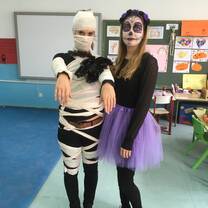 Meghan, an RVF International participant, dressed in festive Halloween costumes with a fellow teacher in a Madrid classroom, showcasing the joy of cultural celebrations and teaching abroad in Spain.