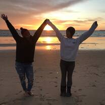 Meghan Massey, an RVF International participant, enjoying a beautiful sunset on a Spanish beach with a friend, showcasing the joy of exploration and unforgettable moments while teaching abroad with RVF International.