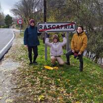 Meghan Massey, an RVF International participant, posing with friends by a Rascafría sign near Madrid, Spain, showcasing the fun and exploration opportunities while teaching abroad with RVF International.