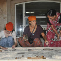 Volunteers learning to cook Indian food