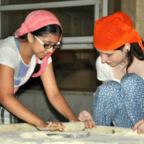 Volunteers learning to cook Indian food