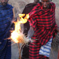 Maasai warrior teaching traditional fire lighting practices
