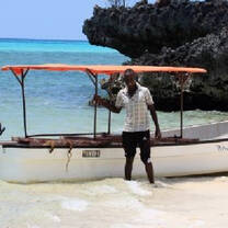 Man with boat by sea