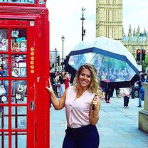 female students in front of red phone booth in London