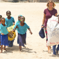 Volunteer with children on the beach