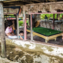 Children with pool table after typhoon