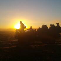 Guide students on a game drive in South Africa during sunset