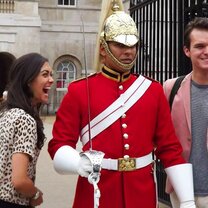 students posing with royal soldier in London