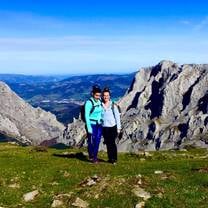 Mindy, an RVF International participant, standing atop a scenic mountain in the Basque Country, Spain, surrounded by breathtaking peaks and lush landscapes, showcasing the adventure and exploration opportunities while teaching abroad.