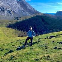 Mindy, an RVF International participant, enjoying a sunny day hiking through the lush green hills of the Basque Country, Spain, surrounded by majestic mountains and beautiful landscapes while teaching abroad.