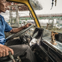 Driver in jeepney in the rain
