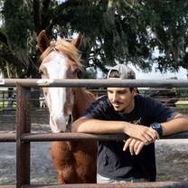 Volunteer and mustang together on the horse rescue ranch in Florida