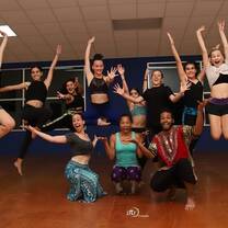 Group of dancers jumping for a photo.